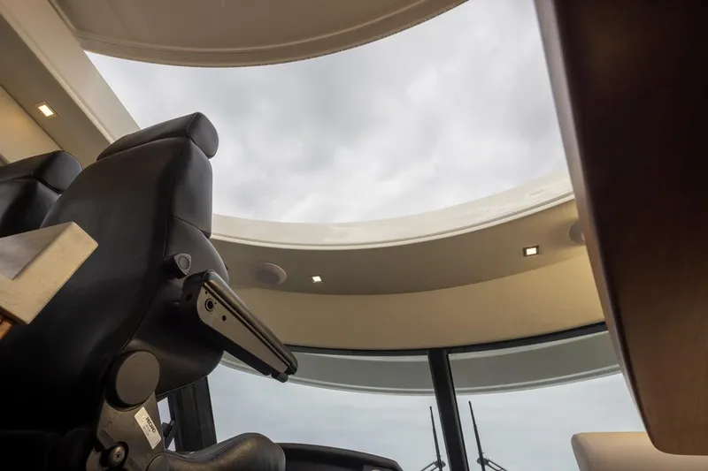 Lucky Dog Yacht Photos Pics Interior view of 2018 Riviera 4800 Sport Yacht with skylight and leather seating.