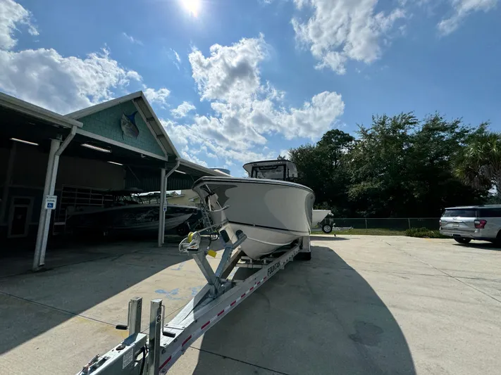  Yacht Photos Pics 2024 Fountain 32 NX boat on trailer under a sunny sky.