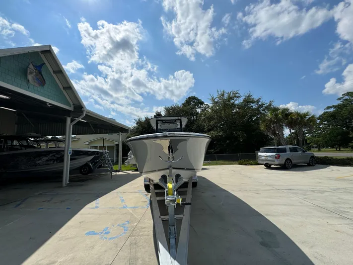  Yacht Photos Pics 2024 Fountain 32 NX boat on trailer under a partly cloudy sky.