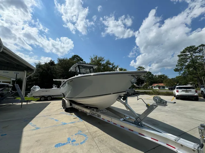  Yacht Photos Pics 2024 Fountain 32 NX boat on trailer under a partly cloudy sky.