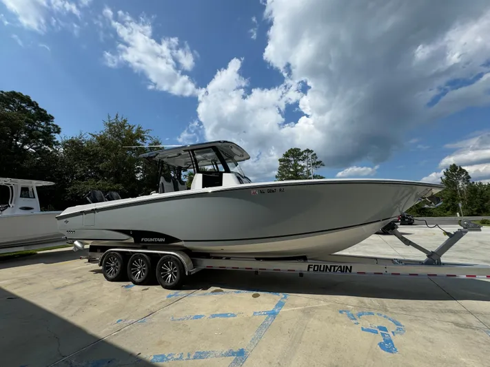  Yacht Photos Pics 2024 Fountain 32 NX boat on trailer under blue sky.