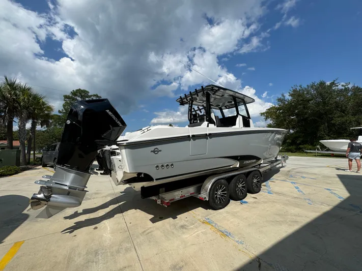  Yacht Photos Pics 2024 Fountain 32 NX boat on trailer under blue sky.