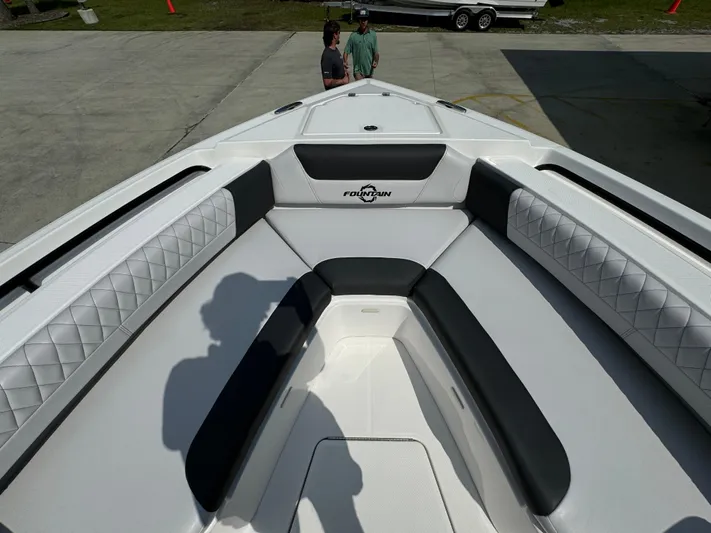  Yacht Photos Pics 2024 Fountain 32 NX boat interior with white and black seating, outdoor setting.