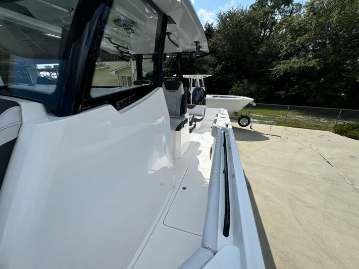  Yacht Photos Pics 2024 Fountain 32 NX boat on trailer, side view, outdoors.