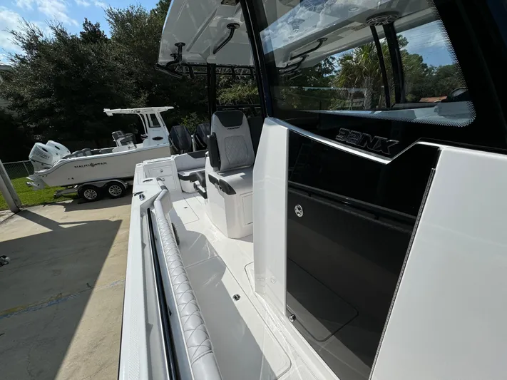  Yacht Photos Pics 2024 Fountain 32 NX boat with sleek design and modern features, docked outdoors.