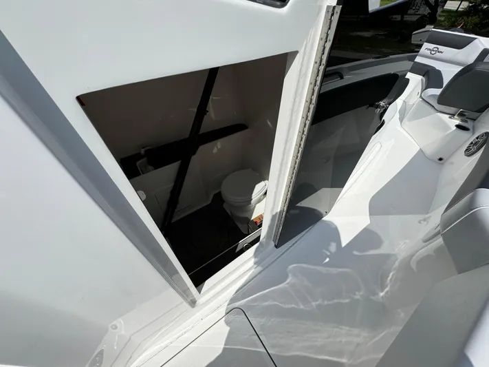  Yacht Photos Pics 2024 Fountain 32 NX boat interior with open cabin door and visible toilet.