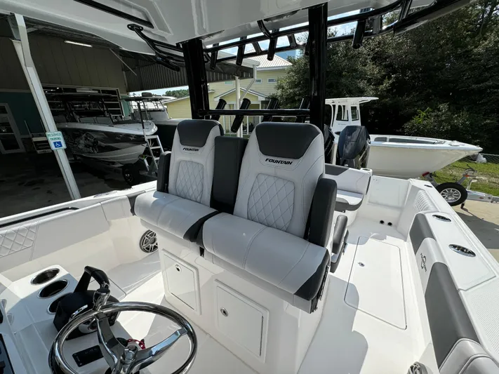  Yacht Photos Pics 2024 Fountain 32 NX boat interior with dual seats and steering wheel.