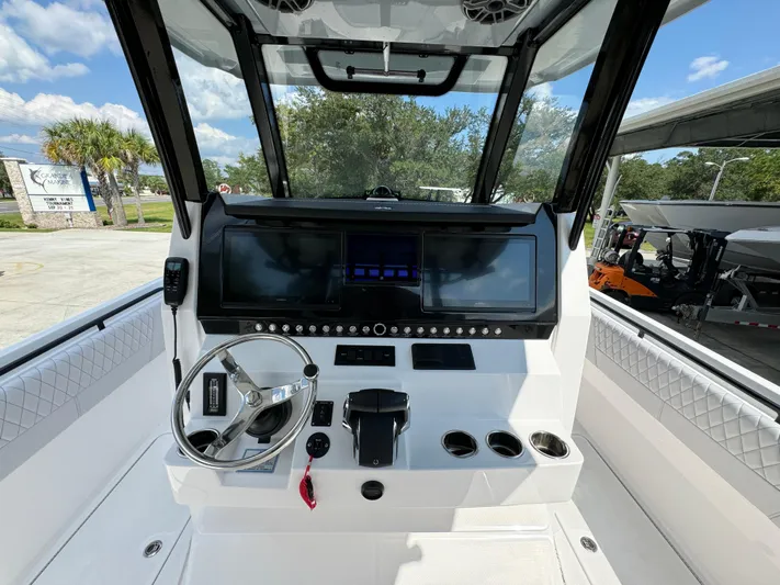  Yacht Photos Pics 2024 Fountain 32 NX boat cockpit with modern steering and control panel.