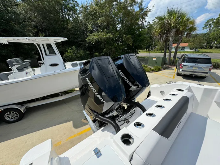  Yacht Photos Pics 2024 Fountain 32 NX boat with dual Mercury engines, parked on a trailer.