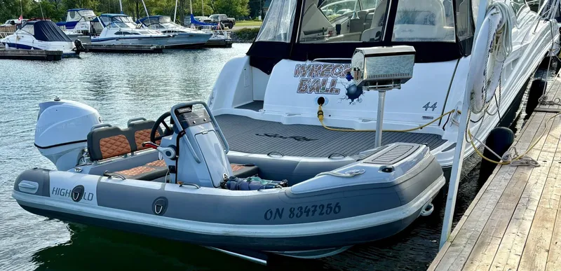  Yacht Photos Pics 2006 Sea Ray 44 Sundancer docked with inflatable boat, marina background.