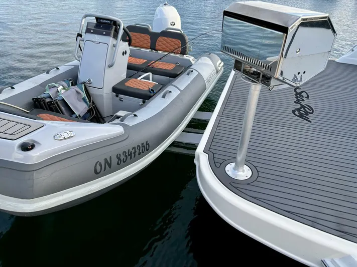  Yacht Photos Pics Inflatable boat docked beside 2006 Sea Ray 44 Sundancer yacht, featuring sleek design and modern amenities.