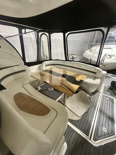  Yacht Photos Pics 2006 Sea Ray 44 Sundancer interior with elegant seating and wooden table.