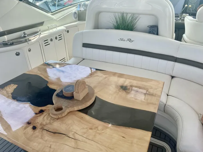  Yacht Photos Pics Luxurious 2006 Sea Ray 44 Sundancer interior with elegant wood table and plush seating.