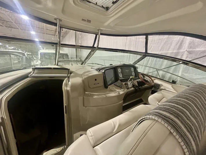  Yacht Photos Pics Interior view of 2006 Sea Ray 44 Sundancer yacht cockpit with helm and seating.