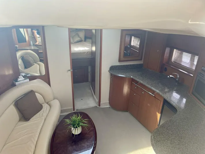 Yacht Photos Pics Luxurious interior of 2006 Sea Ray 44 Sundancer yacht with modern kitchen and cozy seating area.