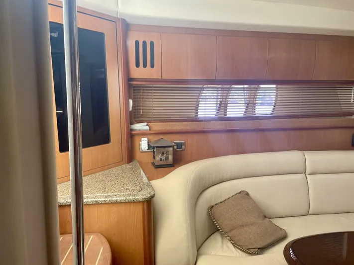  Yacht Photos Pics Interior of 2006 Sea Ray 44 Sundancer yacht with beige seating and wooden cabinetry.