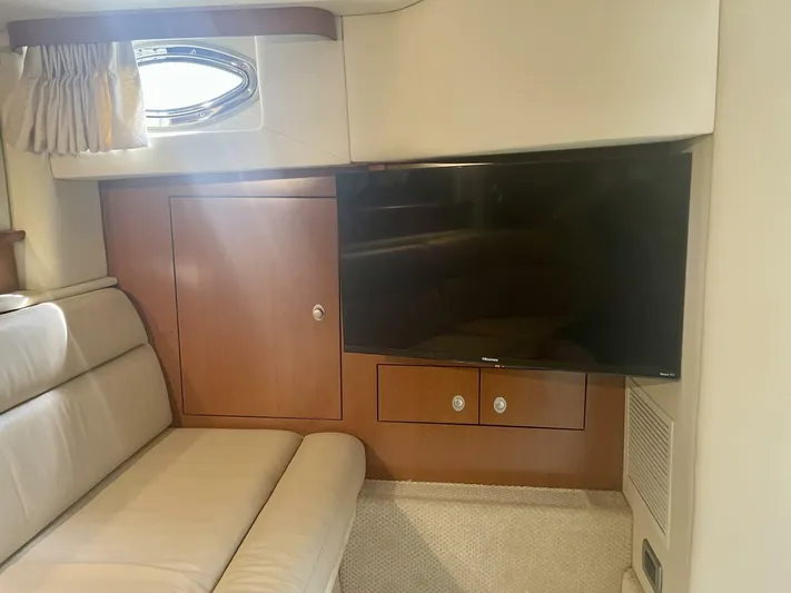  Yacht Photos Pics Interior of 2006 Sea Ray 44 Sundancer with sofa, TV, and wooden cabinetry.
