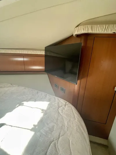  Yacht Photos Pics Interior cabin of 2006 Sea Ray 44 Sundancer with TV and wooden cabinetry.