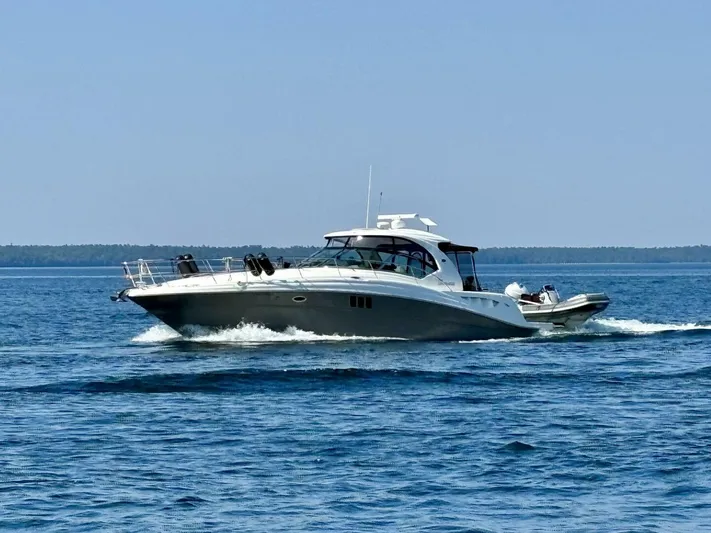  Yacht Photos Pics 2006 Sea Ray 44 Sundancer cruising on open water under clear skies.