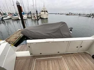 Clarity Yacht Photos Pics Covered boat docked at marina, Navigator 50, 1995 model, with surrounding yachts.