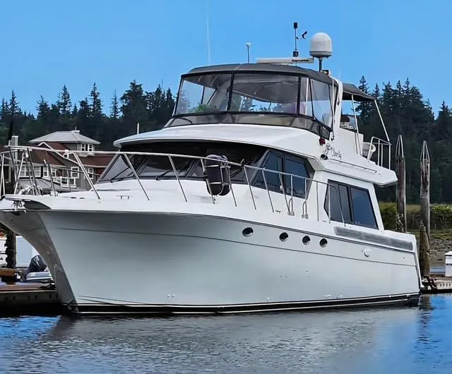 Clarity Yacht Photos Pics Navigator 50 yacht from 1995 docked in a serene marina setting.