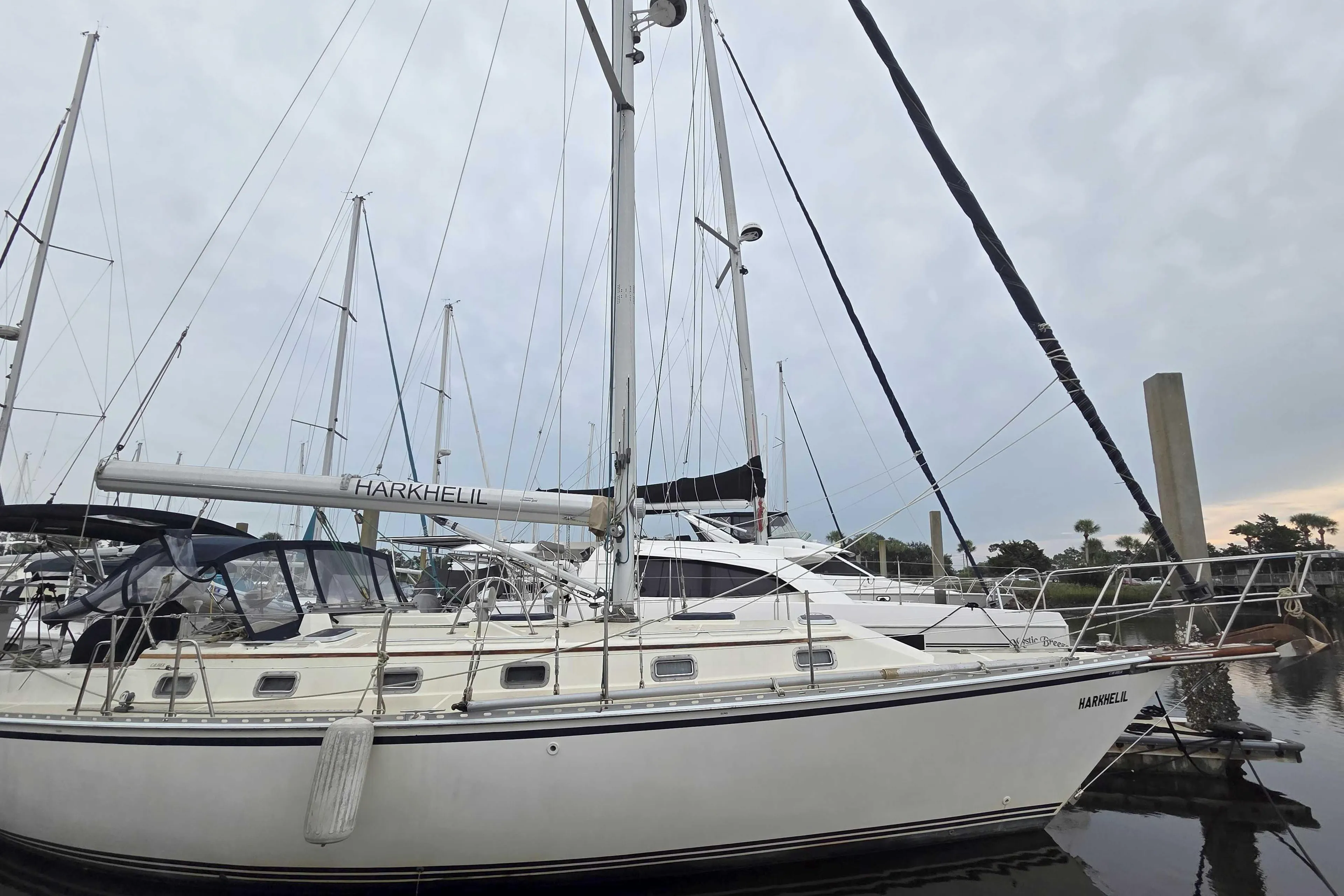 2001 Caliber 40LRC sailboat docked at marina under cloudy sky.