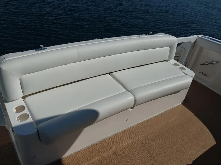 Hope Anne II Yacht Photos Pics White leather seating on 2003 Tiara Yachts 4400 Sovran, overlooking calm water.