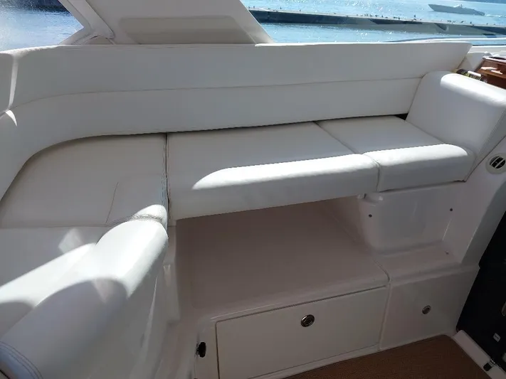 Hope Anne II Yacht Photos Pics Luxurious white seating on 2003 Tiara Yachts 4400 Sovran, overlooking serene waters.