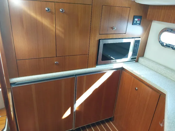Hope Anne II Yacht Photos Pics 2003 Tiara Yachts 4400 Sovran kitchen with wood cabinets and built-in microwave.