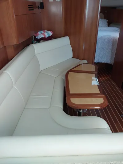 Hope Anne II Yacht Photos Pics Interior of 2003 Tiara Yachts 4400 Sovran with cream seating and wooden table.