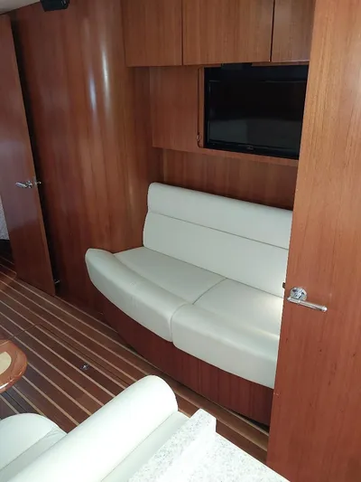 Hope Anne II Yacht Photos Pics Interior of 2003 Tiara Yachts 4400 Sovran with white seating and wood paneling.