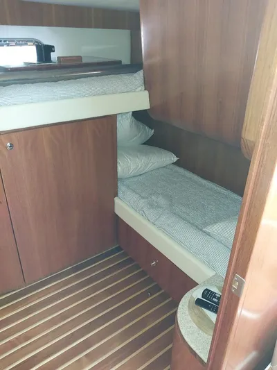Hope Anne II Yacht Photos Pics 2003 Tiara Yachts 4400 Sovran cabin with wooden interior and bunk beds.