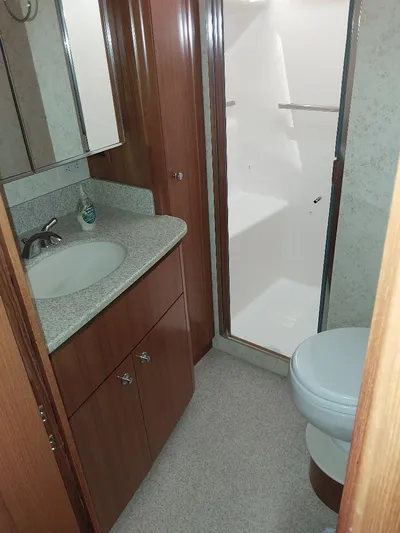 Hope Anne II Yacht Photos Pics 2003 Tiara Yachts 4400 Sovran bathroom with sink, shower, and toilet.