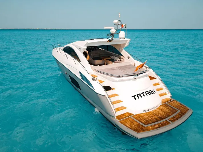  Yacht Photos Pics Sunseeker Predator 60 yacht, 2010 model, cruising on clear turquoise waters.