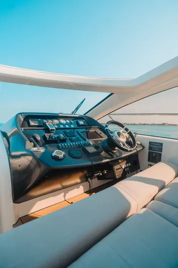  Yacht Photos Pics Sunseeker Predator 60 yacht cockpit, 2010 model, featuring modern controls and luxurious seating.