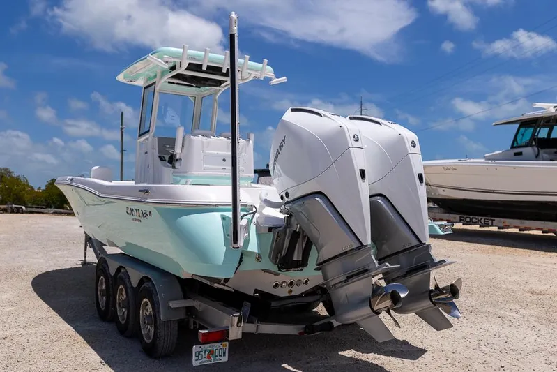  Yacht Photos Pics 2025 Caymas 281 HB boat with dual engines on a trailer, parked outdoors.