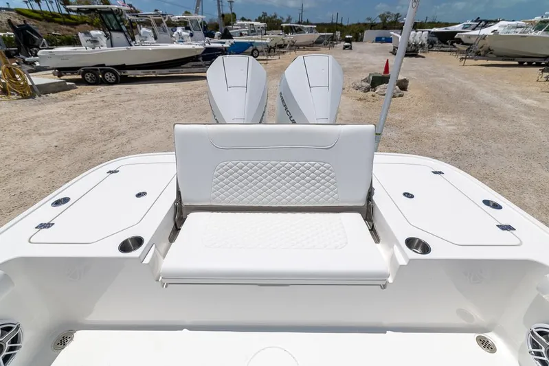  Yacht Photos Pics 2025 Caymas 281 HB boat with dual engines and white seating in a marina setting.