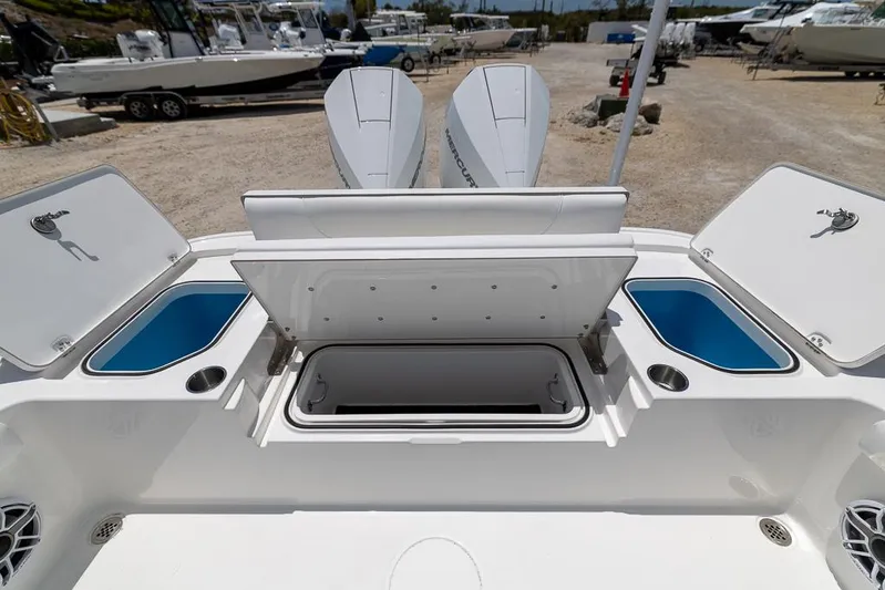  Yacht Photos Pics 2025 Caymas 281 HB boat with open storage compartments and dual outboard motors.