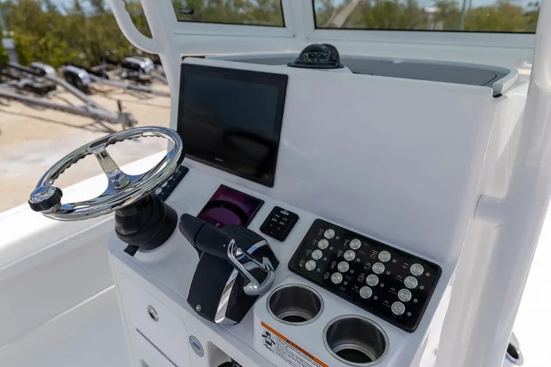  Yacht Photos Pics 2025 Caymas 281 HB boat console with steering wheel, touchscreen, and control panel.