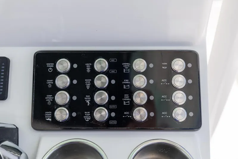  Yacht Photos Pics Control panel of 2025 Caymas 281 HB boat with labeled buttons and switches.