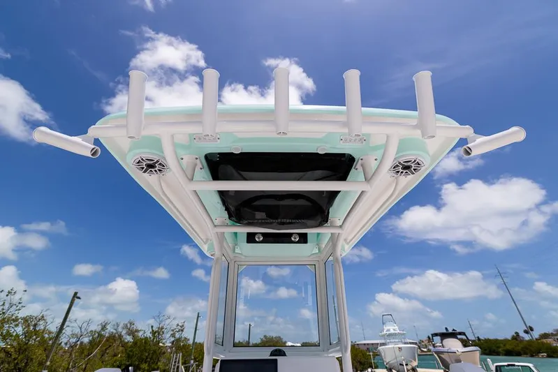  Yacht Photos Pics 2025 Caymas 281 HB boat with rod holders and speakers under a clear blue sky.
