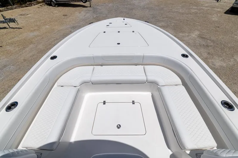  Yacht Photos Pics 2025 Caymas 281 HB boat deck with white seating and storage compartments.