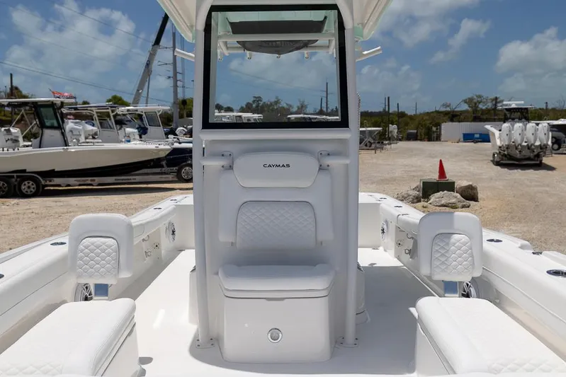  Yacht Photos Pics 2025 Caymas 281 HB boat interior with white seating and console, docked outdoors.