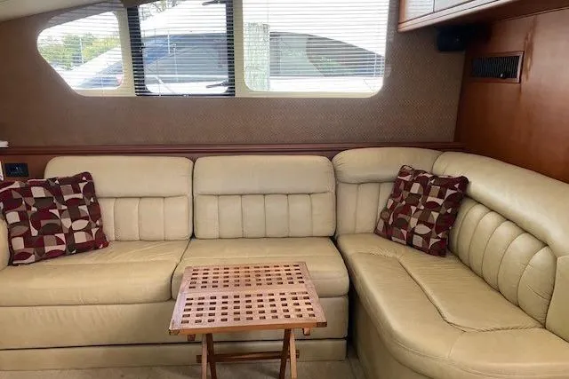  Yacht Photos Pics Luxurious interior of 2006 Silverton 39 Motor Yacht with beige leather seating and decorative pillows.