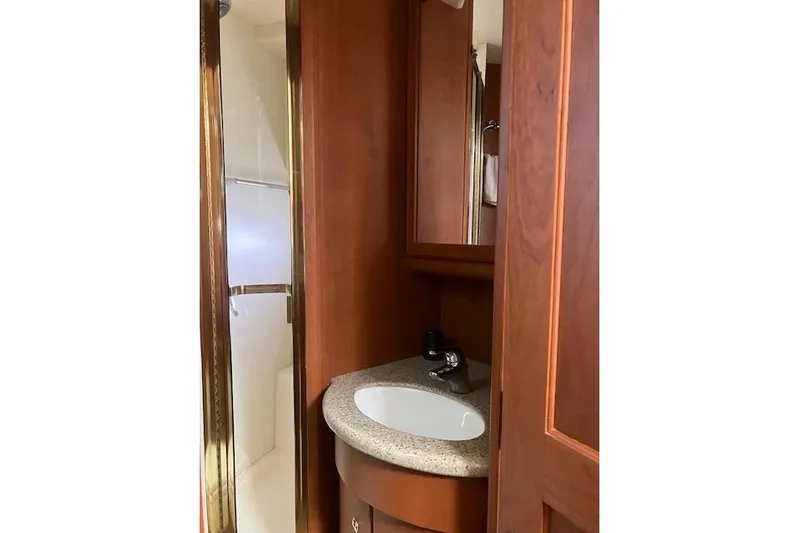  Yacht Photos Pics Bathroom interior of 2006 Silverton 39 Motor Yacht with wooden cabinetry and sink.