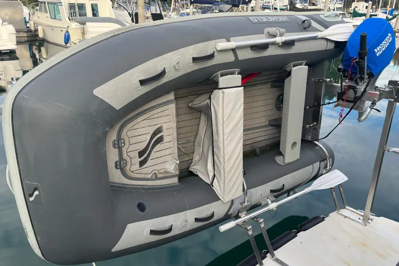 Rockin' Robin Yacht Photos Pics Inflatable dinghy mounted on a 2009 Ranger Tugs R-29 boat, docked at a marina.