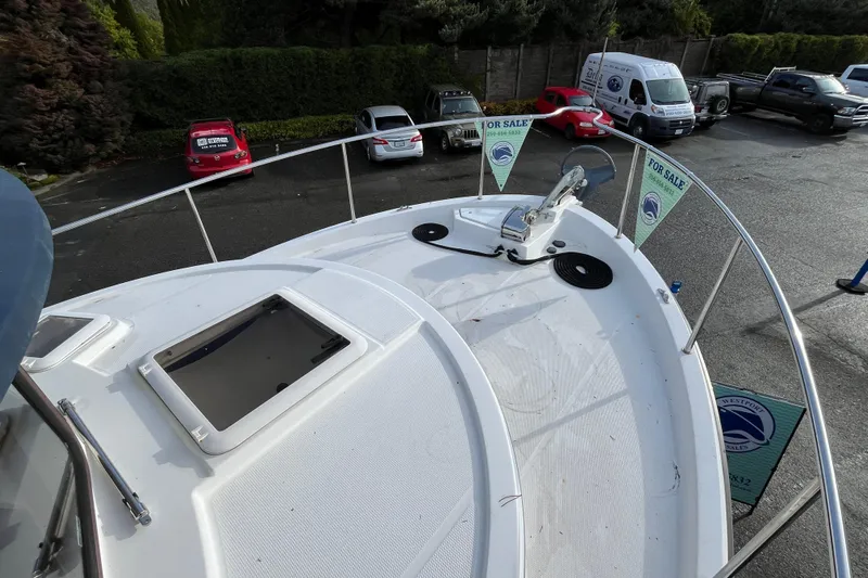 Rockin' Robin Yacht Photos Pics 2009 Ranger Tugs R-29 boat for sale, docked with visible deck and surrounding vehicles.