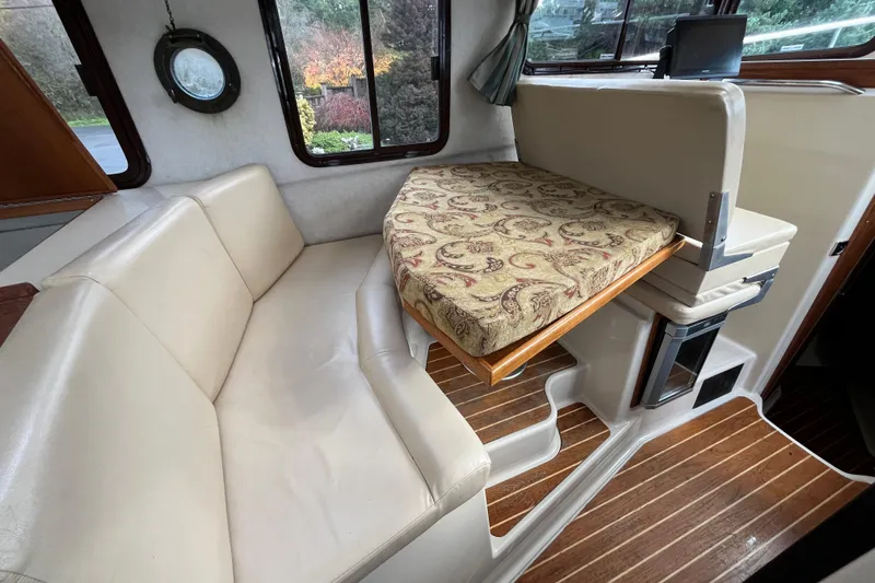Rockin' Robin Yacht Photos Pics Interior of 2009 Ranger Tugs R-29 with beige seating and patterned cushion.