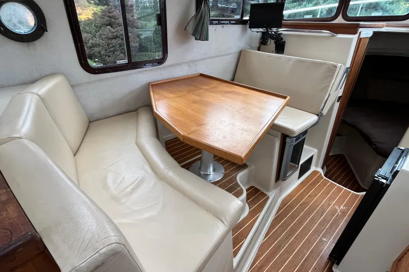 Rockin' Robin Yacht Photos Pics 2009 Ranger Tugs R-29 interior with beige seating and wooden table.