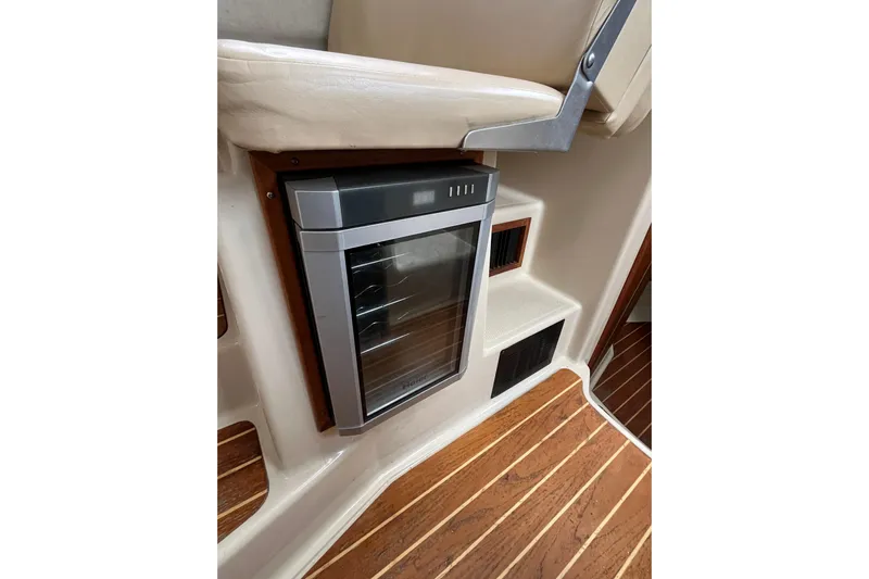 Rockin' Robin Yacht Photos Pics 2009 Ranger Tugs R-29 interior with compact fridge and wooden flooring.